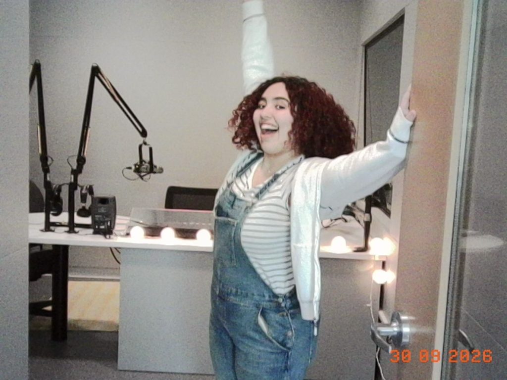 "Sofia at the Door"
Blog post author, Sofia, standing in the doorway to Simmons Radio Studio A while she holds the door open.